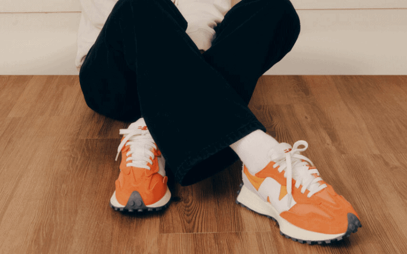 a person wearing orange and white shoes